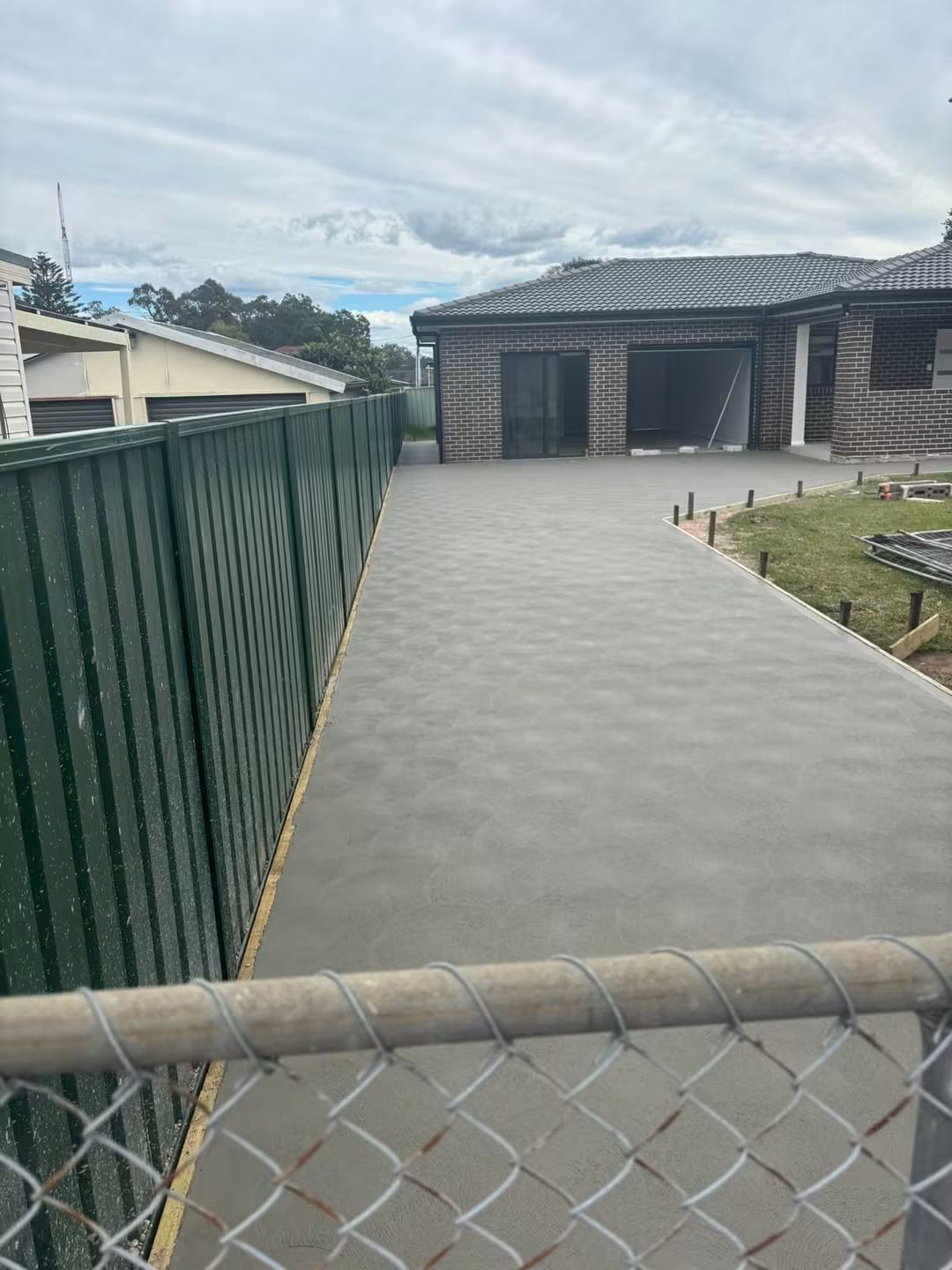 Charcoal concrete pool surround by Upscale Concrete Services in Sydney